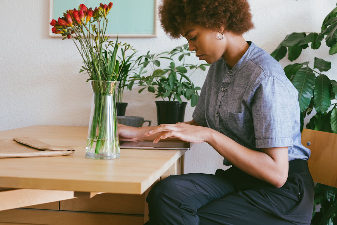 a woman sitting at a wooden desk.