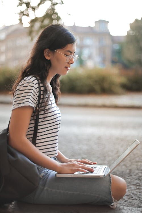 a woman using her laptop outdoors.