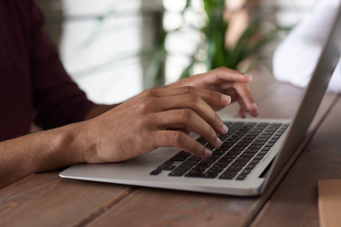 a person typing on a laptop.