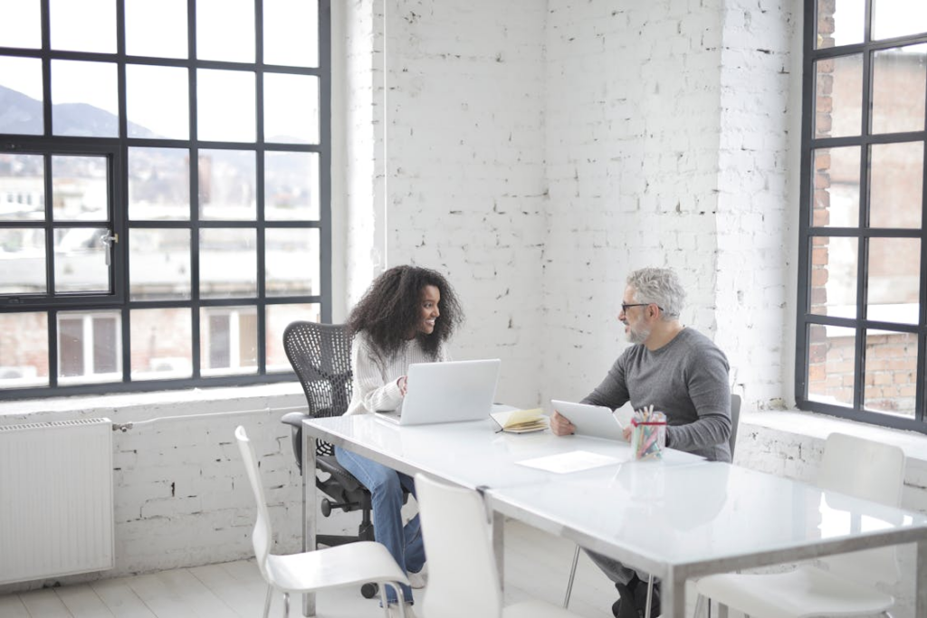 two people sitting at a desk.