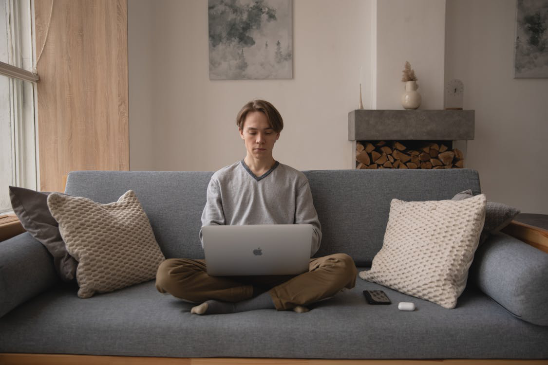 a man sitting and using his computer.