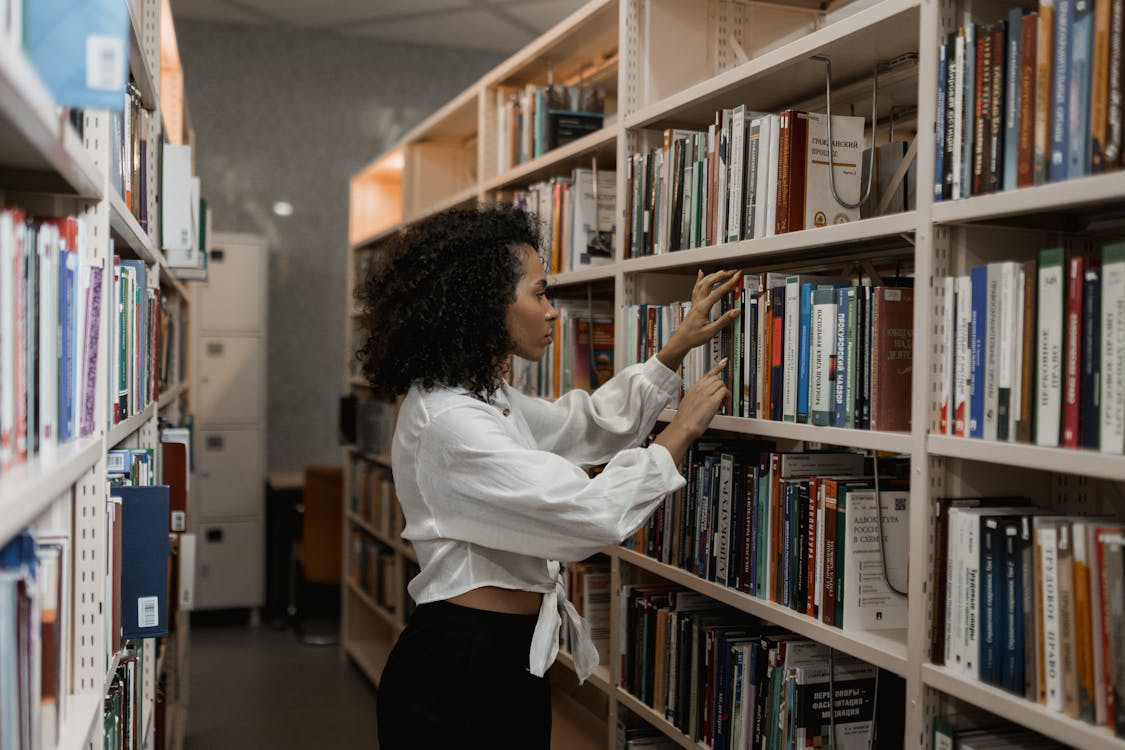 a woman looking at books.