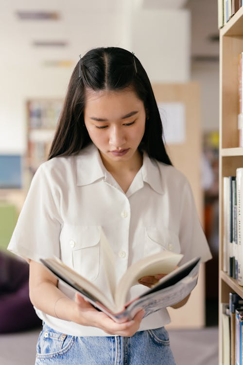 a woman going through a book.